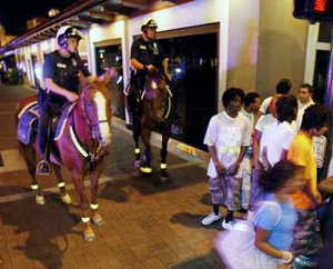 Policemen on horses patroling black teenagers