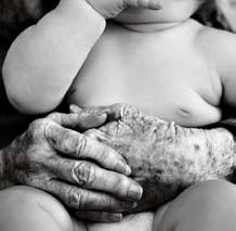 hands of an elder holding a baby