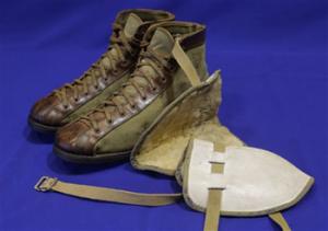 Vintage leather and canvas basketball shoes and a set of knee pads are shown as part of an exhibit entitled "The Black Fives," at the New-York Historical Society in New York. Dozens of teams flourished between 1904 and 1950 in what became known as the Black Fives Era, an often-overlooked piece of black history that is the subject of an exhibition opening at the New-York Historical Society on March 14.